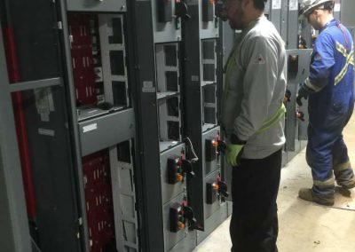 Electricians working on industrial switchgear