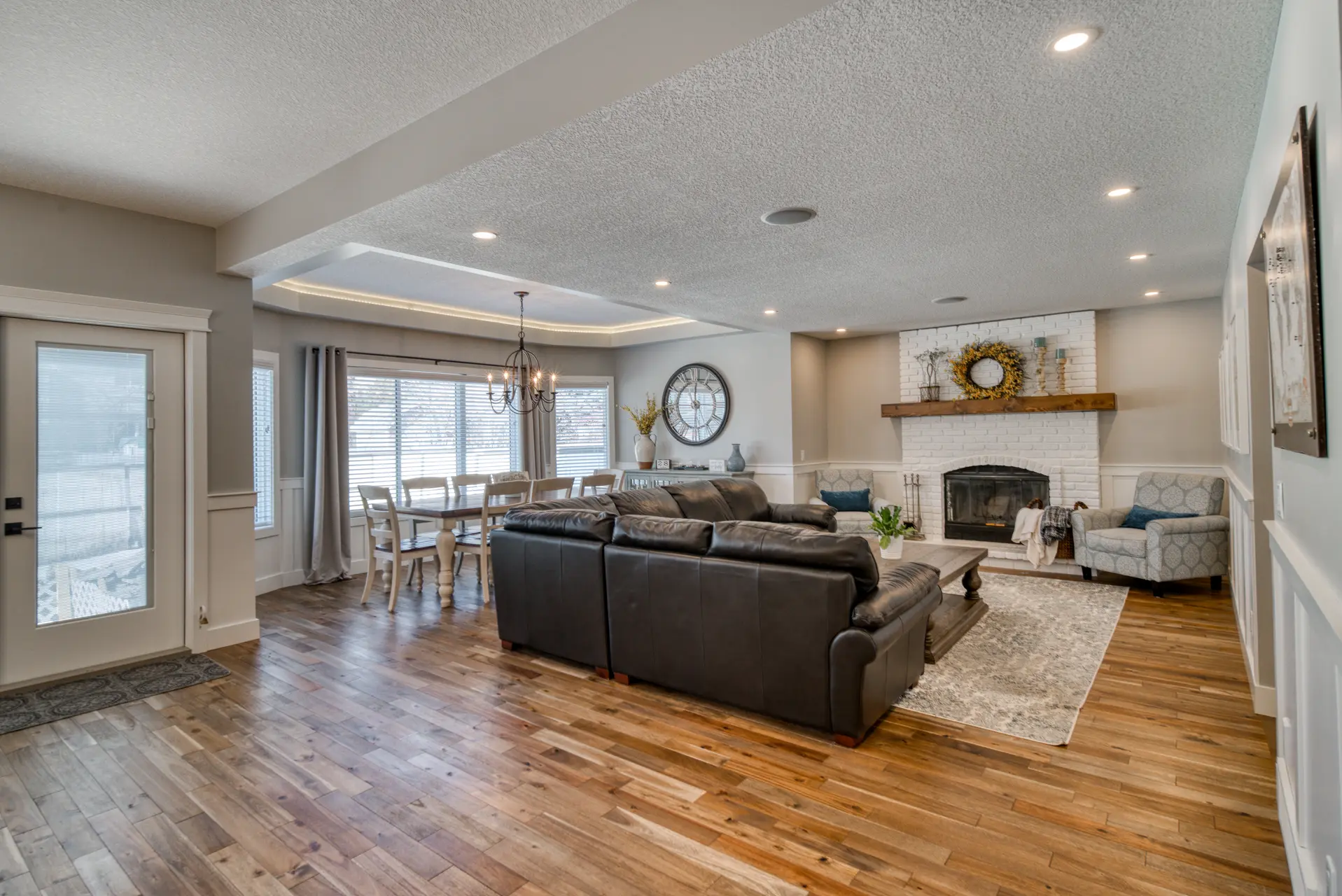 Finished Calgary living space with layered lighting and recessed fixtures